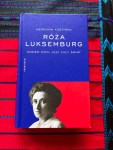 Rosa Luxemburg biography on a red table runner