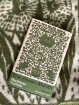 The Green Month book on a green and white blanket
